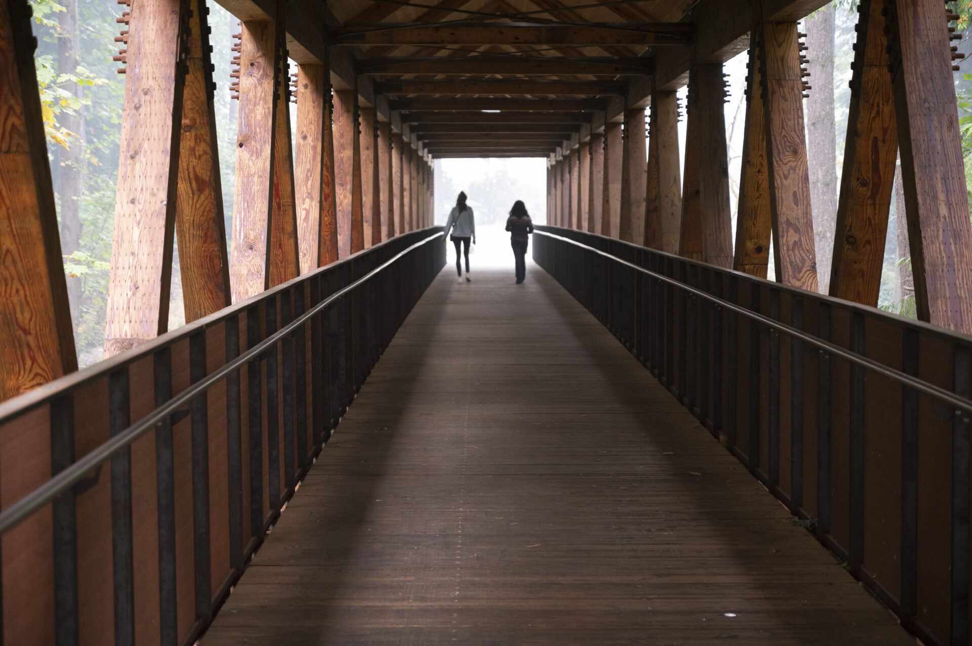 Photo of two people walking across the bridge.