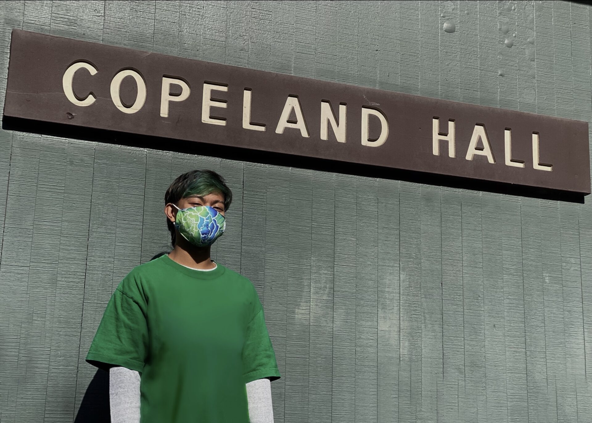 Ezri Rayes in front of Copeland Hall sign