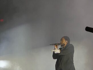 Kendrick Lamar raps into a microphone.