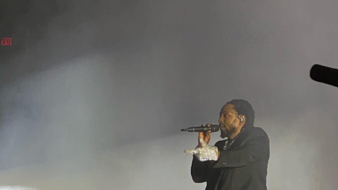Kendrick Lamar raps into a microphone.