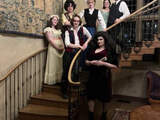 Student actors from the three classes pose in Victorian costume on Frank Manor’s spiral staircase after their performance.