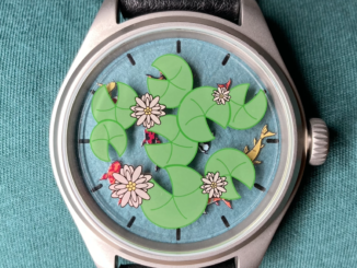Photo of a watch with a blue face beneath lily pads, flowers, and hidden koi fish.