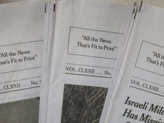Photo of NYT papers with the text "All The News That's Fit To Print" centered