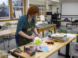Photo of a person using materials in the art studio
