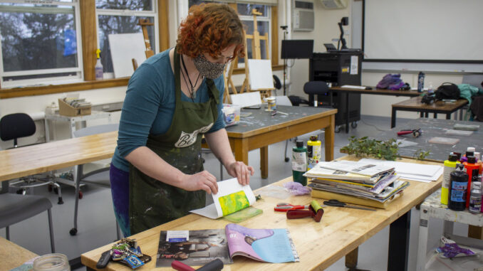 Photo of a person using materials in the art studio