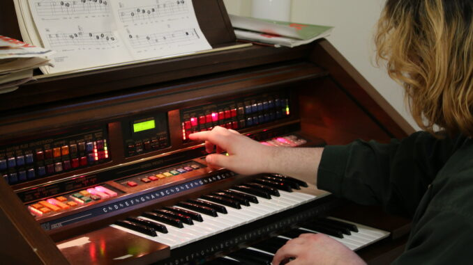 Photo of Leo Bernstein Newman playing the organ