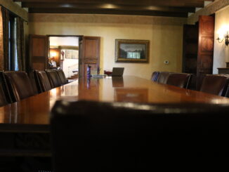 Photo of meeting table with empty chairs