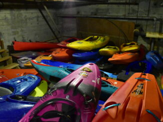 Photo of a large pile of kayaks