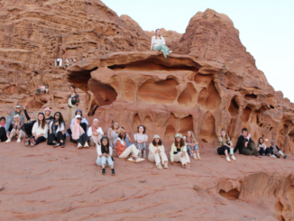 Photo of students on red rocks on a trip to Jordan.