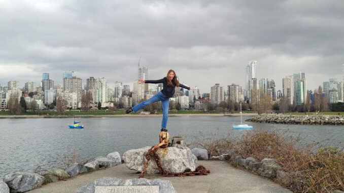 Rosalie posing and smiling, arms outstretched, in Canada (photo)