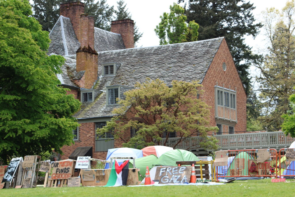 The Frank Manor House stands behind the students' encampment.