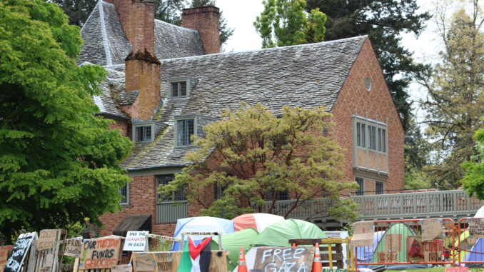 The Frank Manor House stands behind the students' encampment.