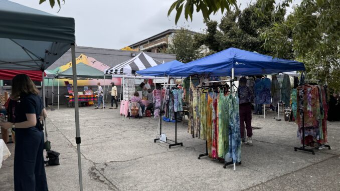 Photo of tents full of clothing and art