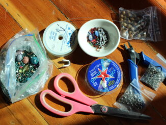 Photo of Tools essential for making jewelry, including scissors, wire, beads, and pliers