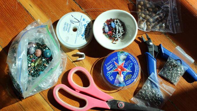 Photo of Tools essential for making jewelry, including scissors, wire, beads, and pliers